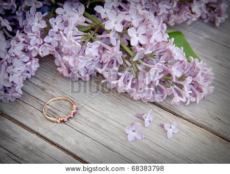 Ring And Lilac On Wood