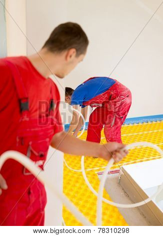 Installing underfloor heating and colling pipes modern system