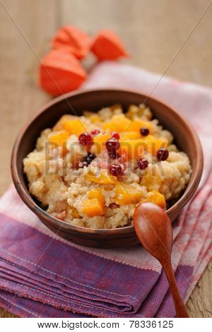 Millet Porrige With Pumpkin In Clay Bowl With Wooden Spoon