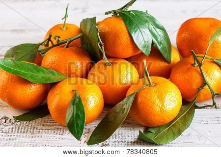 Tangerines With Leaves On A Wooden Table