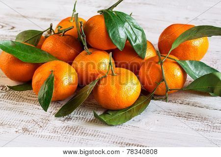 Tangerines With Leaves On A Wooden Table