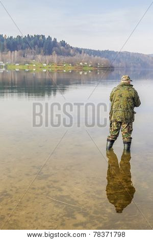 Senior fisherman fish in Solina Lake, Bieszczady, Poland