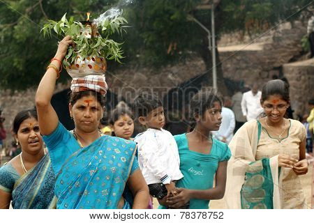 Hindu devotees carry Bonam to the temple in Golconda fort in Hyderabad,India