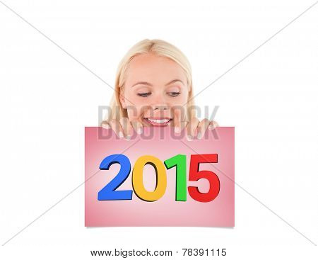 Woman peeking over a whiteboard against pink card