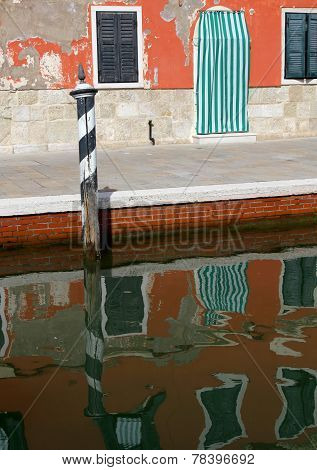 Colorful Houses Of The Island Of Burano Reflected In Canal