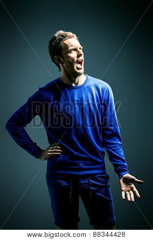 Young handsome man says a loud resolute speech. Pilitics. Theater.