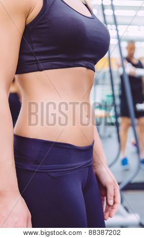 Slim waist closeup of sporty woman with black sportswear
