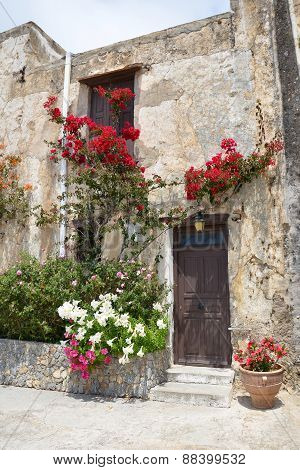 The monastic wall with door and flowers