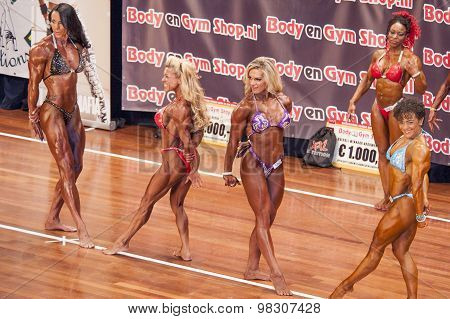 Female Bodybuilders Flex Their Triceps In A Lineup Comparison