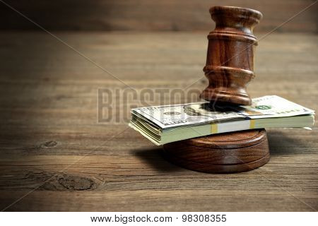 Bundle Of Money, Judges Gavel And Soundboard On Wooden Table