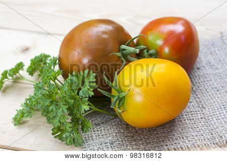 Assorted tomatoes: orange, pink, black tomatoes with parsle