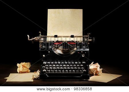 Old vintage typewriter with blank paper