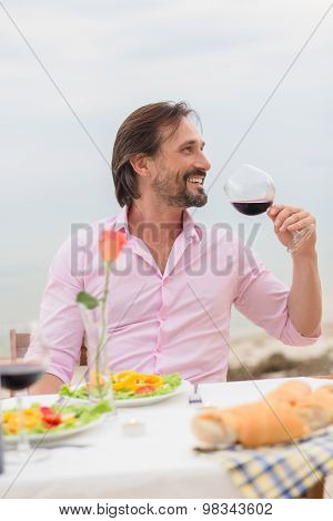 Handsome man drinking wine