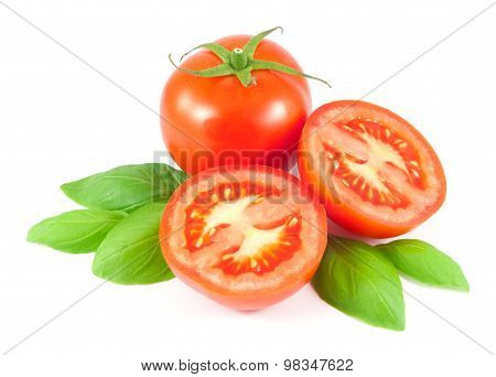 Whole and sliced tomato with basil leaves isolated on white