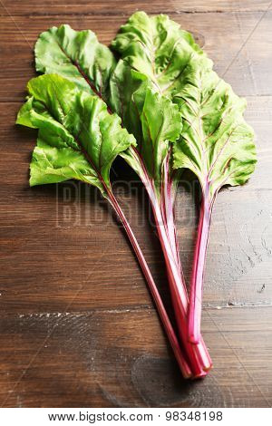 Fresh swiss chard on wooden table, close up