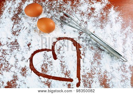 Eggs and corolla on flour background