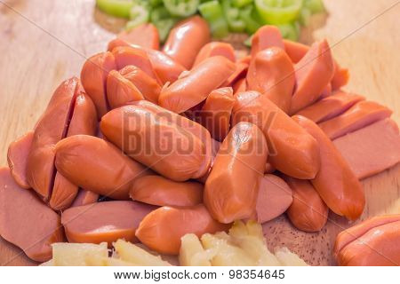 Preparing sausage and vegetables woman hands vintage tone.