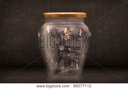 Businessman traped in jar with graph chart symbols concept on background