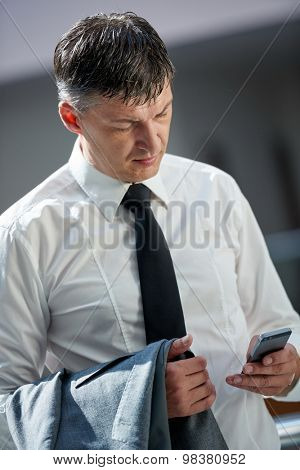 business man using phone at modern office space