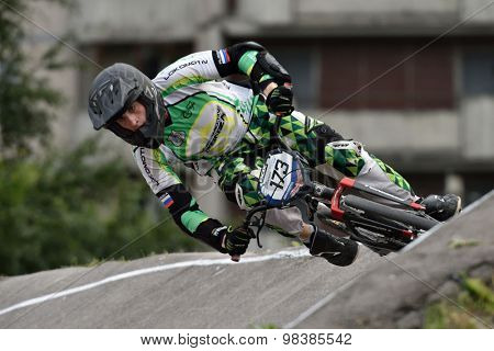 ST. PETERSBURG, RUSSIA - AUGUST 6, 2015: Unidentified biker on the berm in the BMX race Cruiser. The competitions is a stage of the BMX racing championship of Russia
