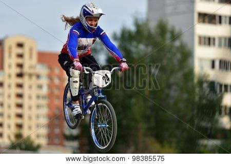 ST. PETERSBURG, RUSSIA - AUGUST 6, 2015: Unidentified female biker in the BMX race Cruiser. The competitions is a stage of the BMX racing championship of Russia