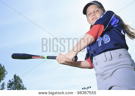 A Baseball girl hitter over a blue sky