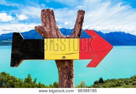 Belgium Flag wooden sign with river on background