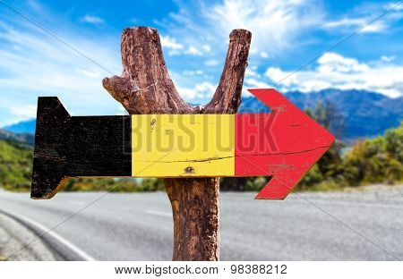 Belgium Flag wooden sign with road background