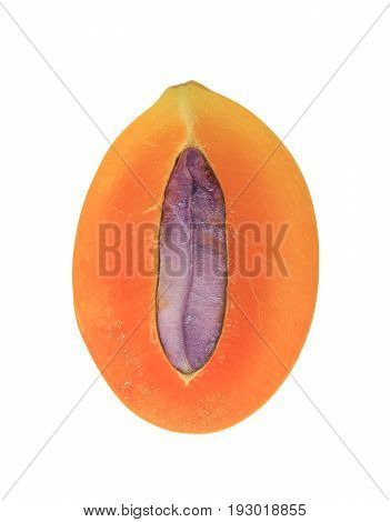 Texture of bright orange color fresh ripe Marian Plum fruit cut in half with purple seed on white background, vertical photo