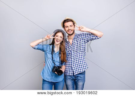 Family Memories. Vacation Together. Happy Young Couple In Casual Wear And Hats Are Embracing On Ligh