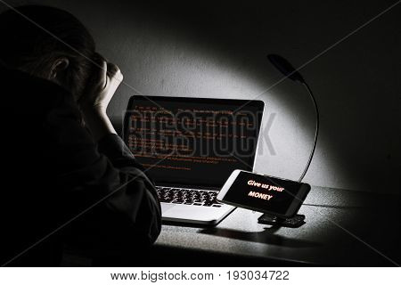 Young lady frustrated confused and headache by WannaCry ransomware attack on desktop screen notebook and smartphone cyber attack internet security concept
