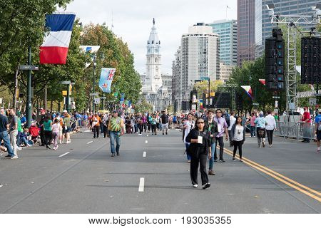 PHILADELPHIA, PA - SEPTEMBER 26: Crowds of people arrive on the Benjamin Franklin Parkway in Center City Philadelphia to see Pope Francis at the World Meeting of Families on September 26, 2015.