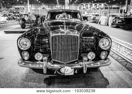 MAASTRICHT NETHERLANDS - JANUARY 14 2016: High-performance luxury car Bentley Continental S2 Drophead Coupe by Park Ward 1963. Black and white. International Exhibition InterClassics & Topmobiel 2016