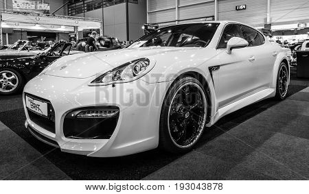 MAASTRICHT NETHERLANDS - JANUARY 15 2016: Full-size luxury car Porsche Panamera Grand GT 2012. Black and white. International Exhibition InterClassics & Topmobiel 2016
