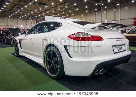 MAASTRICHT NETHERLANDS - JANUARY 15 2016: Full-size luxury car Porsche Panamera Grand GT 2012. Rear view. International Exhibition InterClassics & Topmobiel 2016
