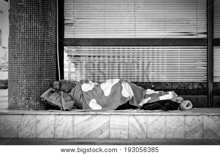 Homeless. Homeless woman sleeps on the street. Black and white.