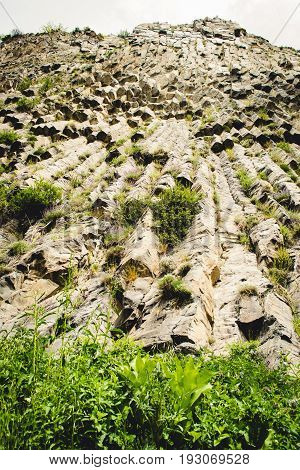 Mountain unique geological formation called Symphony of Stones. Basalt rock. Ecotourism. Nature background. Adventure holiday. Armenia, Garni. Travel vacation. Climbing tourism concept. Beautiful place