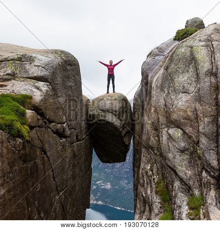 Happy people relax in cliff during trip Norway. Kjerag hiking route.