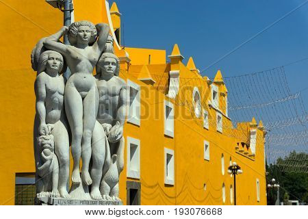 PUEBLA MEXICO - MARCH 2: Statues next to a historic yellow church in Puebla Mexico on March 2 2017