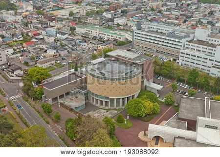 HAKODATE JAPAN - MAY 24 2017: Hakodate Performing Arts Center with City Northern Pacific Fishery Document Museum in Hakodate Hokkaido Island Japan. View from Goryokaku Tower