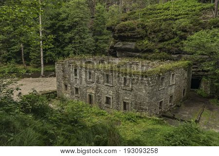 Dolsky mill in national park with old ruin of mill in north Bohemia