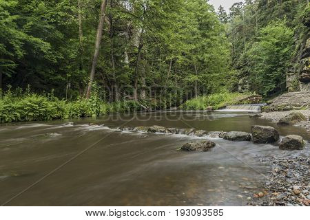 Dolsky mill in national park with old ruin of mill in north Bohemia