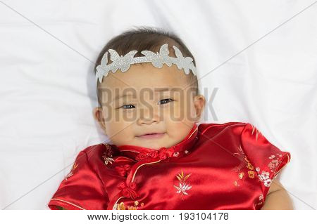 Asian cute new born girl baby with gesture of congratulation happy chinese new yeras.