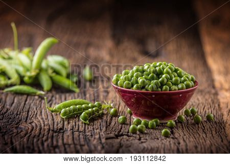 Peas. Fresh bio homemade peas and pods on old oak board. Healthy fresh green vegetable - peas and pods.