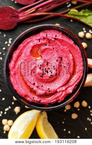 Beet hummus, creamy and delicious in a ceramic bowl