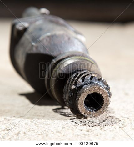 The part from the car lies on the concrete
