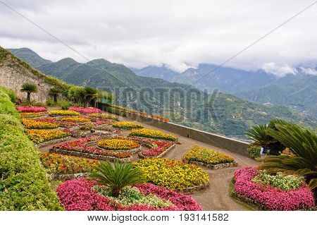 The beautiful colorful garden of Villa Rufolo under heavy autumn clouds high up on the slopes of the Amalfi Coast - Ravello Campania Italy
