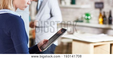 Closeup photo of woman using tablet computer. Only half profile can be seen.