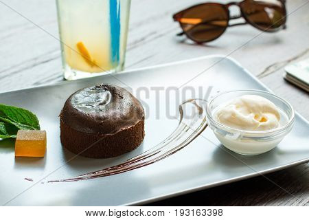 Chocolate fondant with ice cream on a wooden background