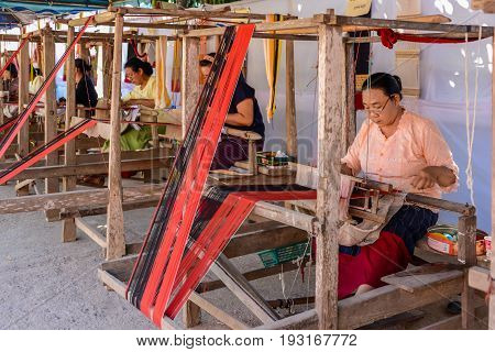 CHIANGMAI THAILAND - JANUARY 24 2015: Indigenous women are demonstrating weaving fabric in 22nd Traditional Skirt Fabric and The Indigenous Product and Culture Festival in Mae Chaem of Chiangmai Thailand